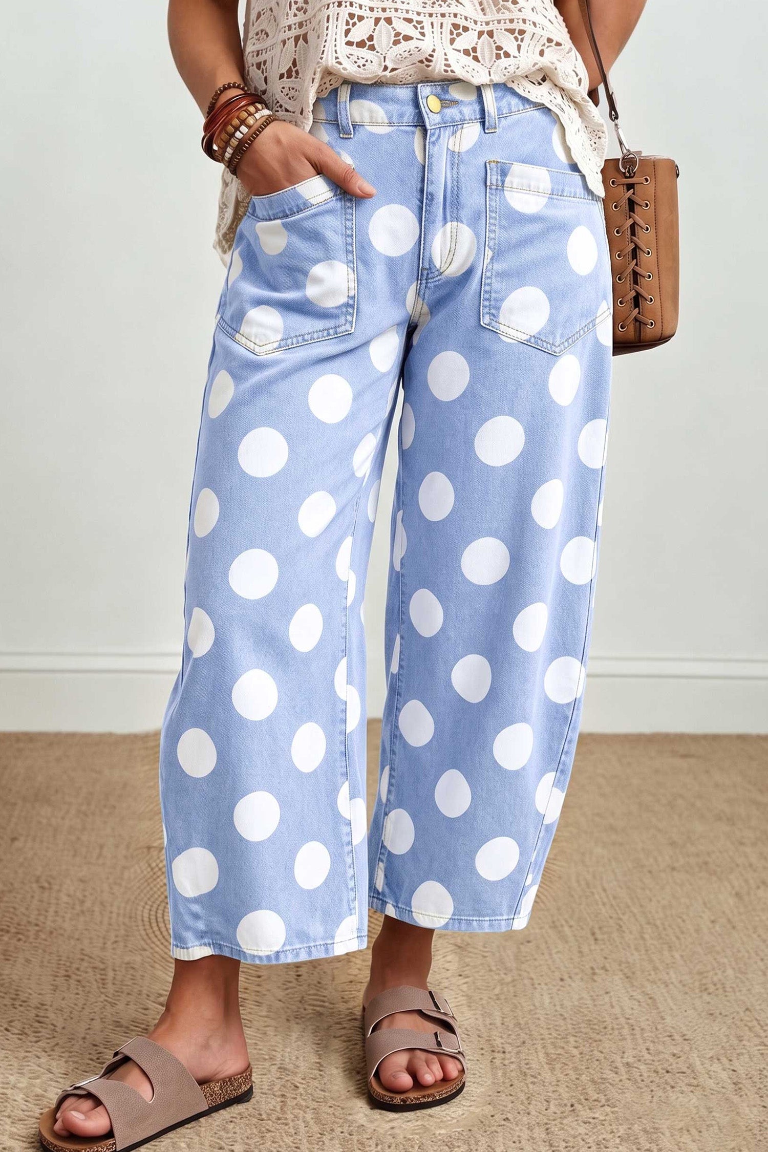 Sky blue polka dot barrel leg ankle jeans with a cream crochet top, front view