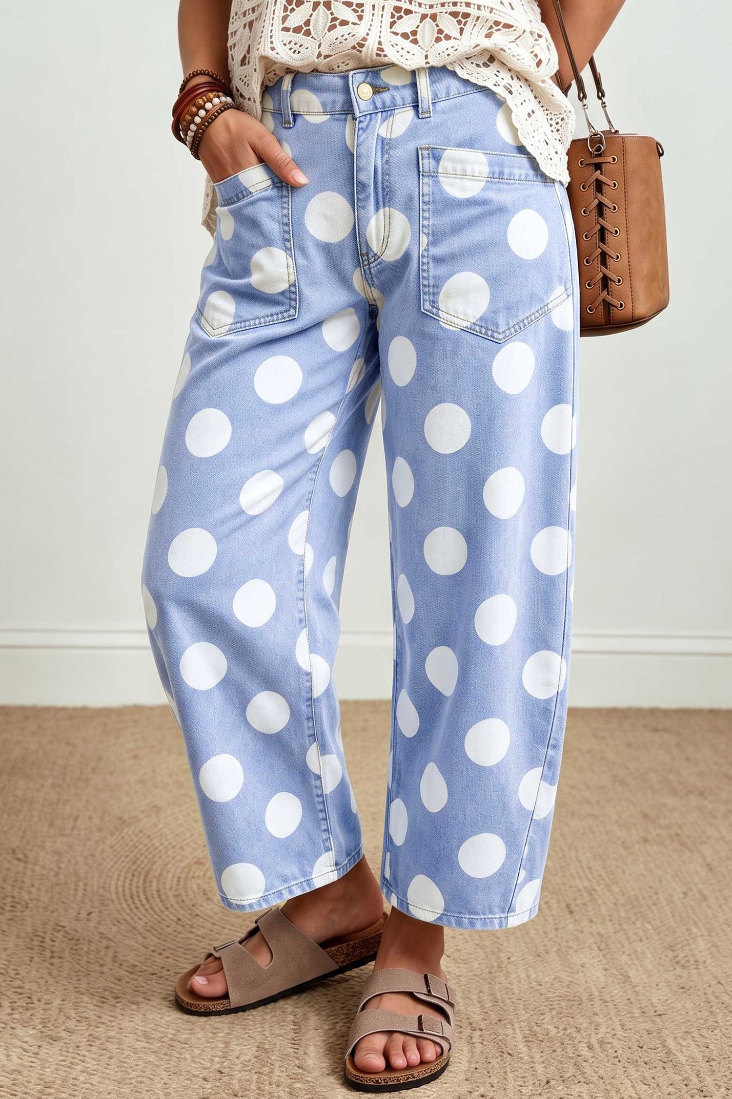 Side view of sky blue barrel leg jeans with large white polka dots