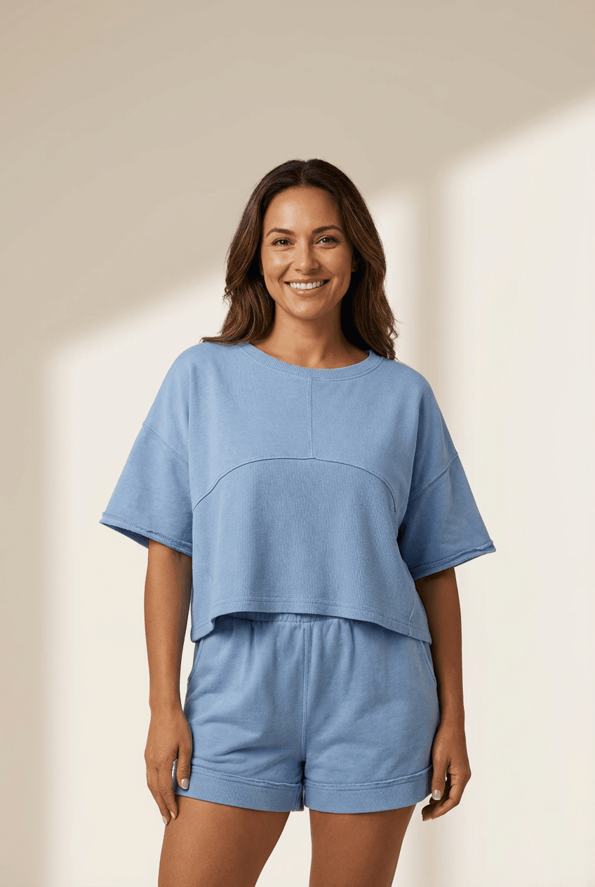 Woman wearing a blue outfit on a beige background