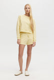 Woman wearing a yellow outfit on a white background