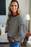 Woman wearing a black and white striped sweater in a living room setting