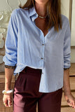 Person wearing a blue and white striped shirt with burgundy pants indoors.