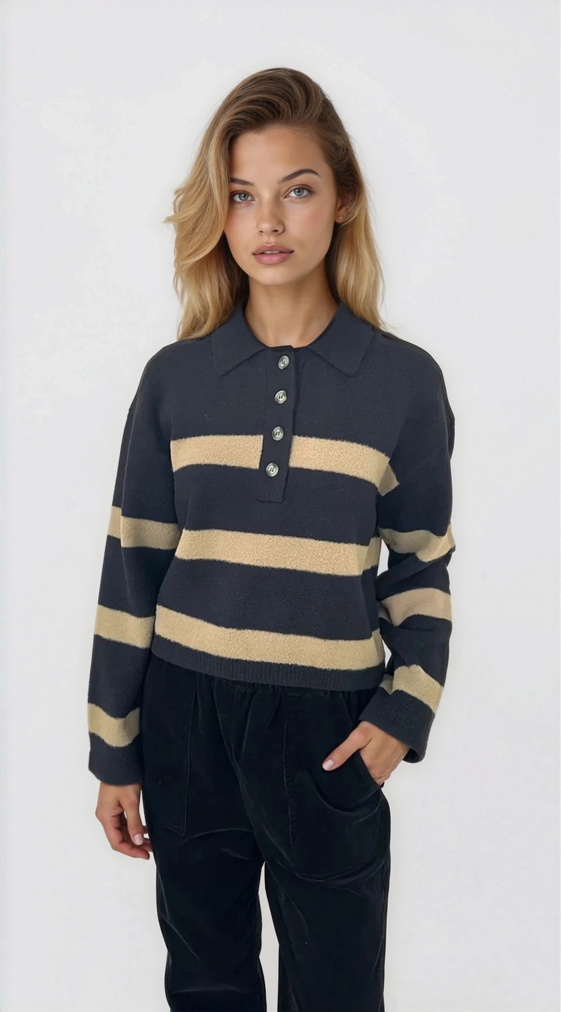 Woman wearing a navy and beige striped sweater on a white background