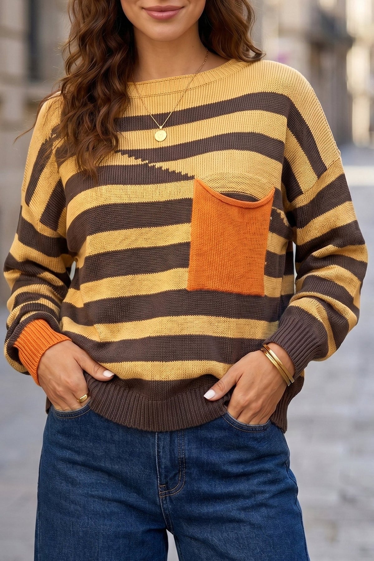Woman in a cozy striped knit sweater accents and cuffs.

