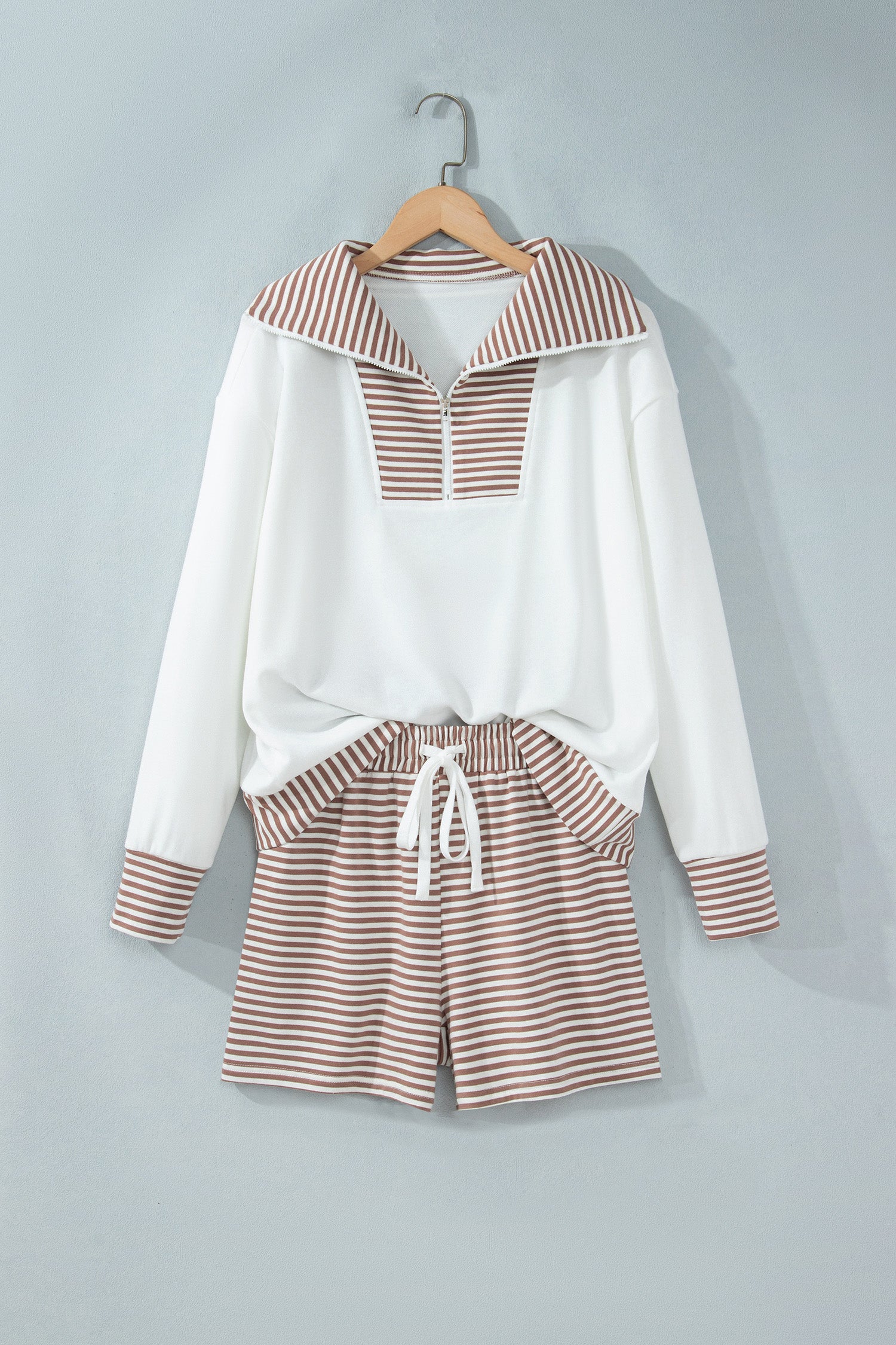 Khaki striped half zip top and drawstring shorts set on a hanger, front view