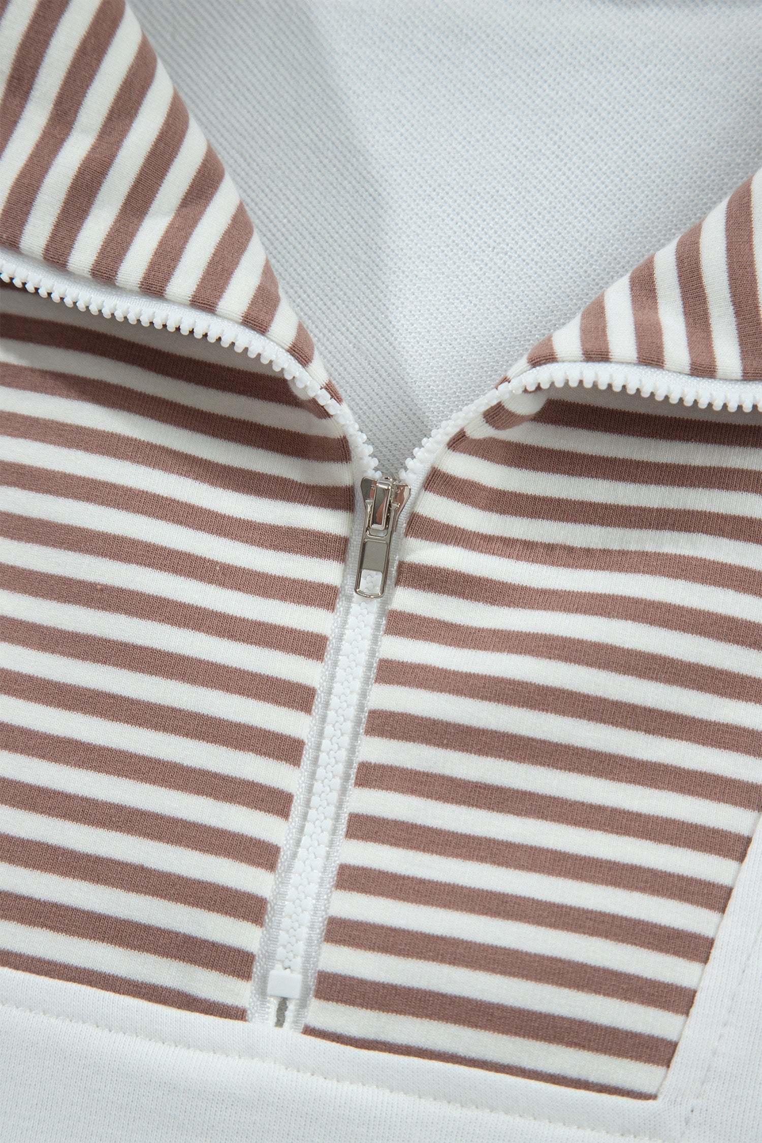 Striped half zip placket and fold-over collar close-up