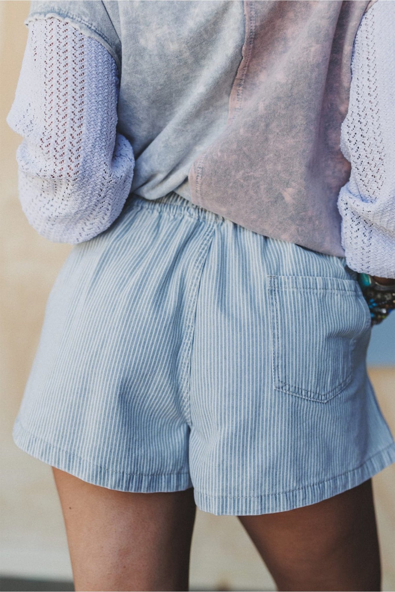 Light blue striped shorts worn by a person with a neutral background