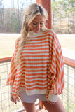 Orange and cream striped textured top with balloon sleeves, styled view