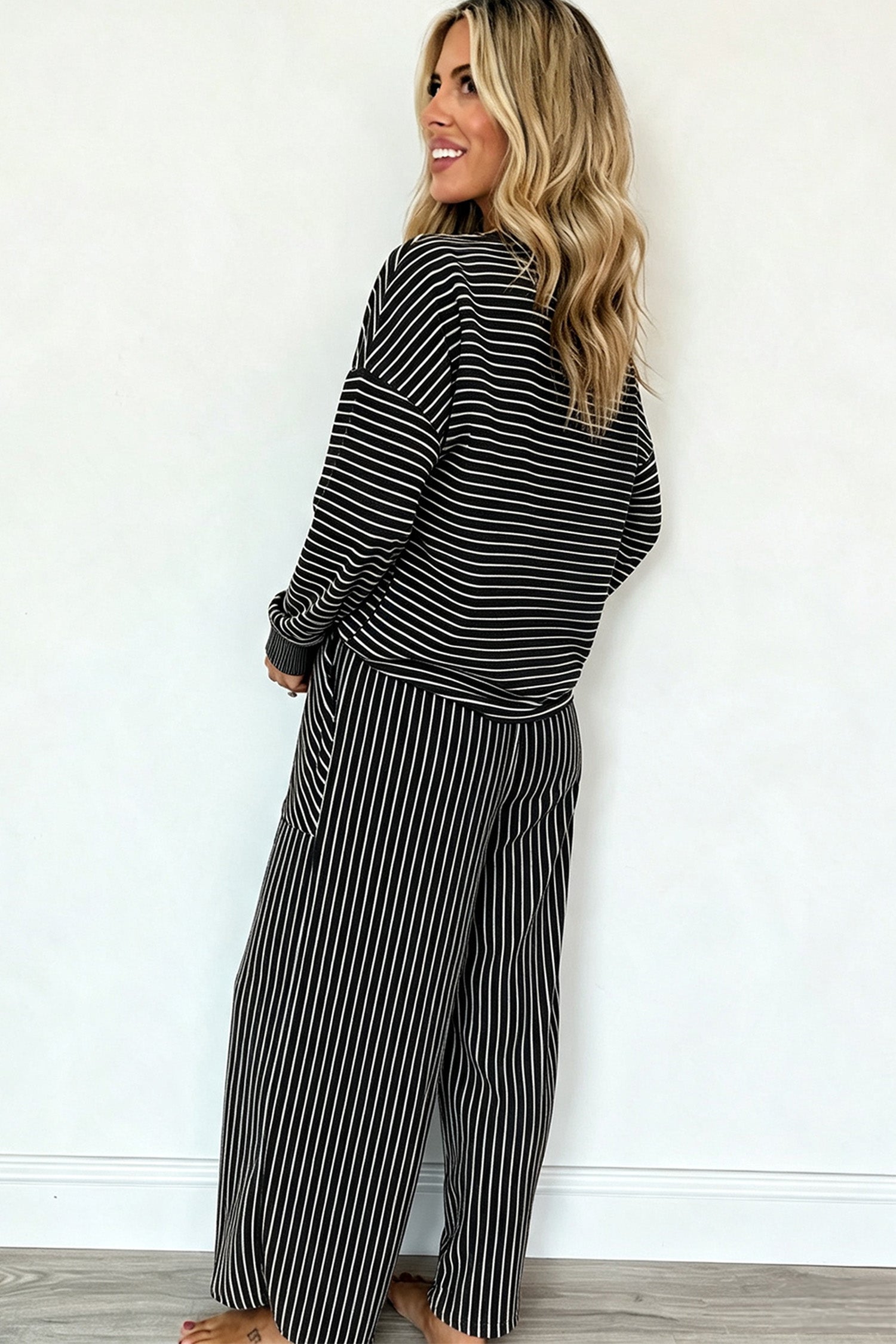 Black striped pullover and vertical stripe wide leg pants set, back view