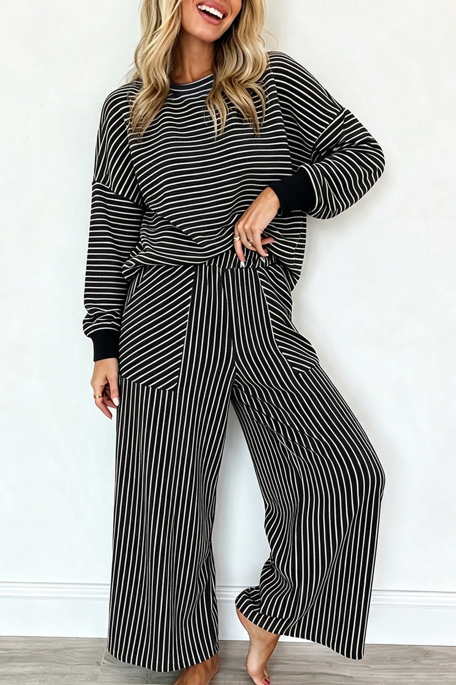 Women's black and cream striped pullover and wide leg pants set, front view