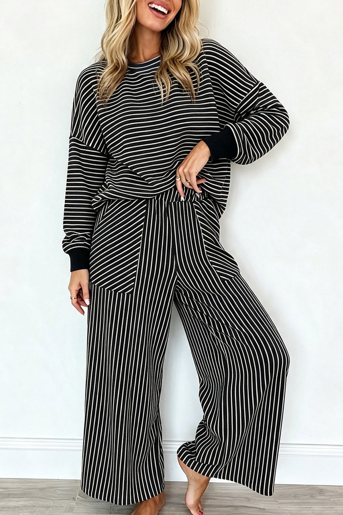 Women's black and cream striped pullover and wide leg pants set, front view