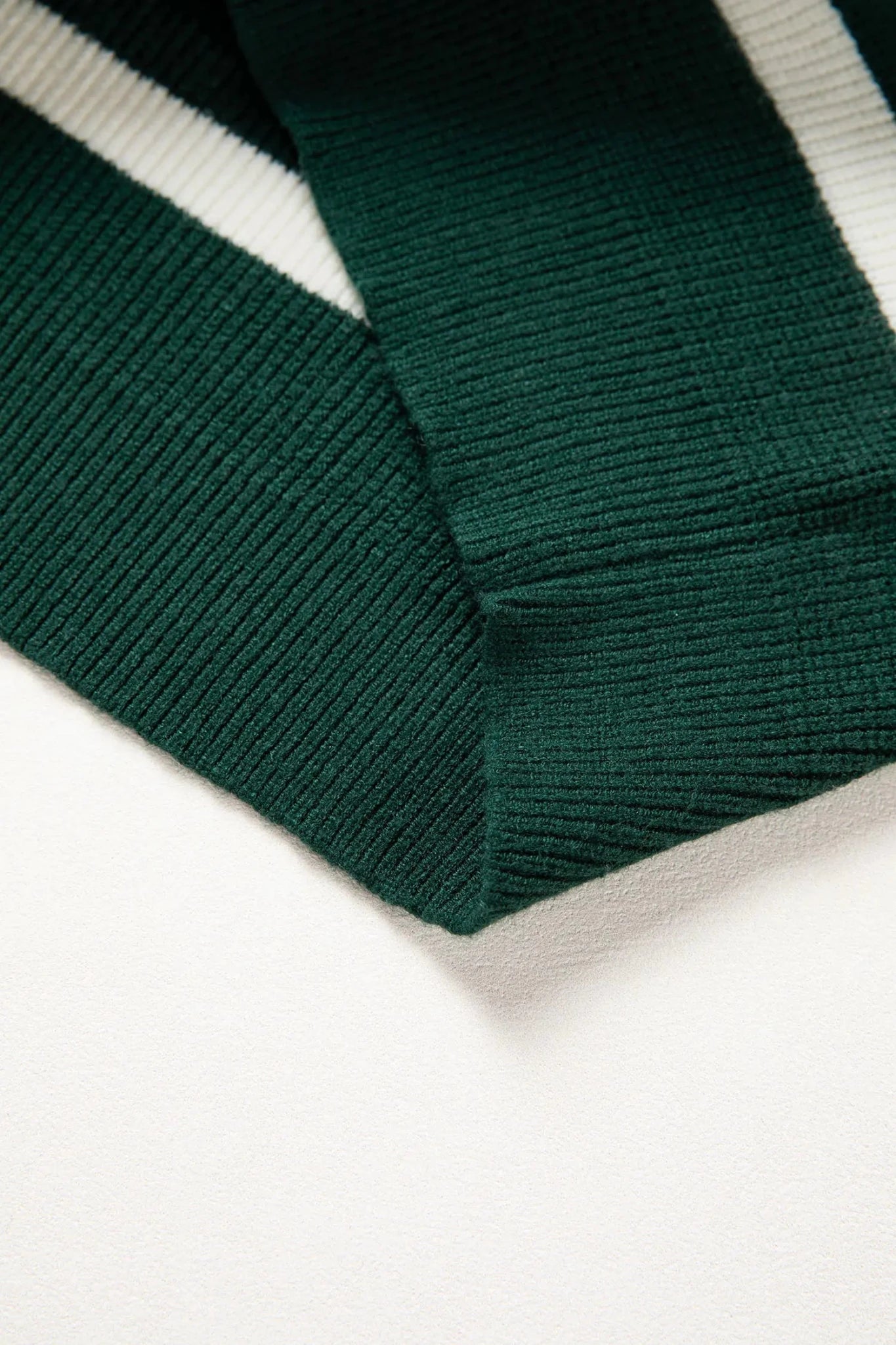 Close-up of green and white striped fabric on a white background