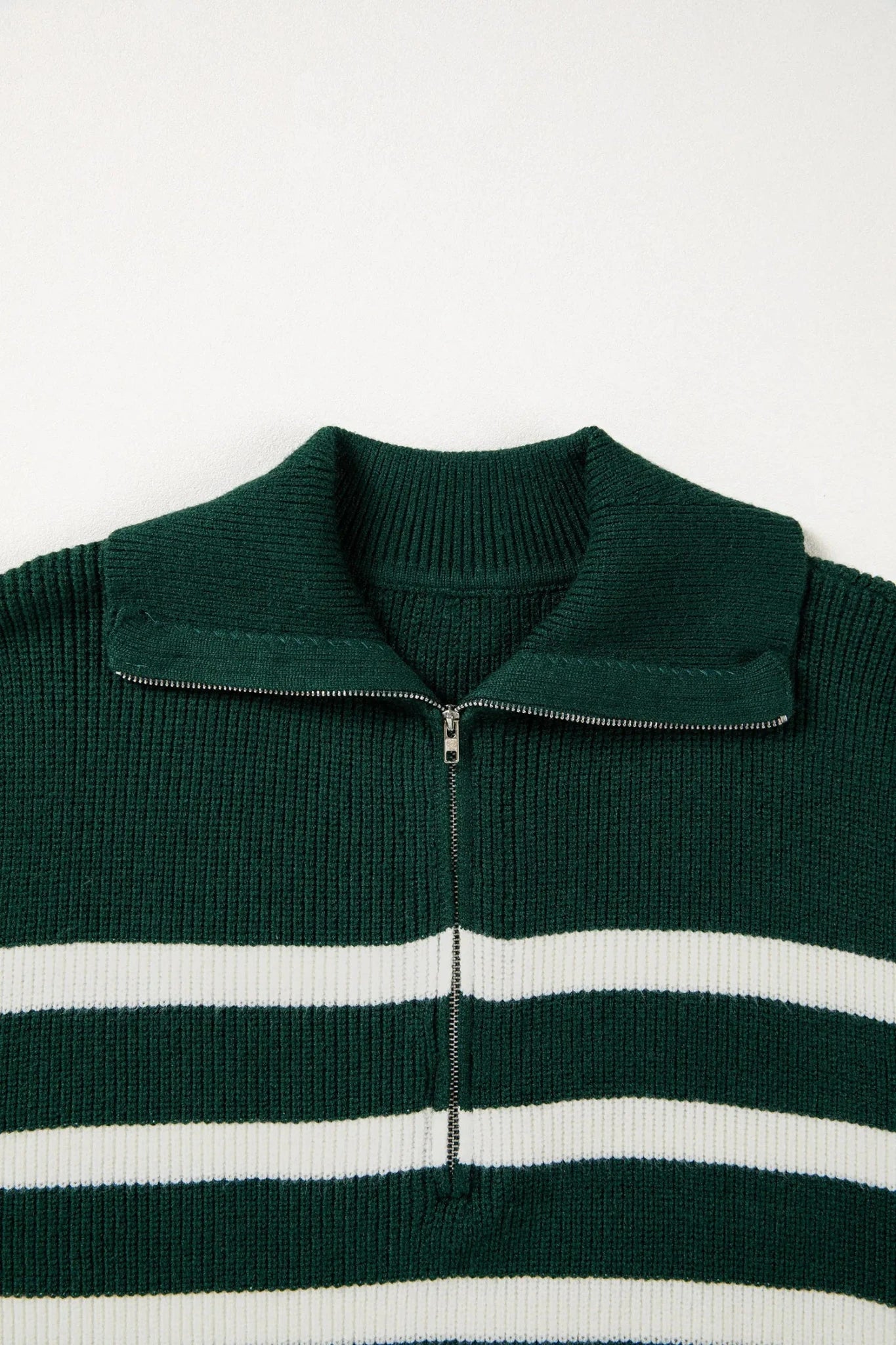 Green sweater with white stripes on a white background
