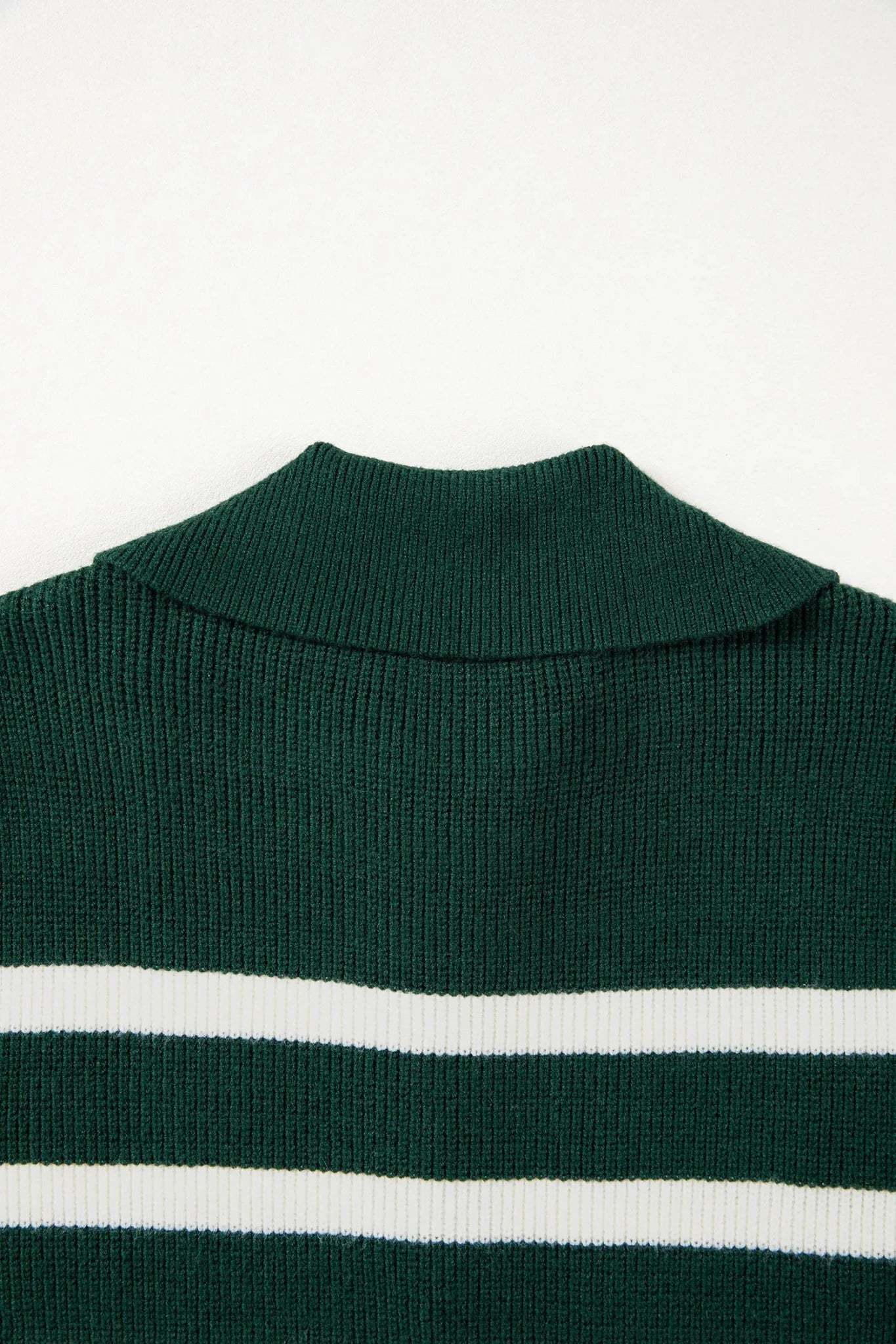 Green sweater with white stripes on a white background