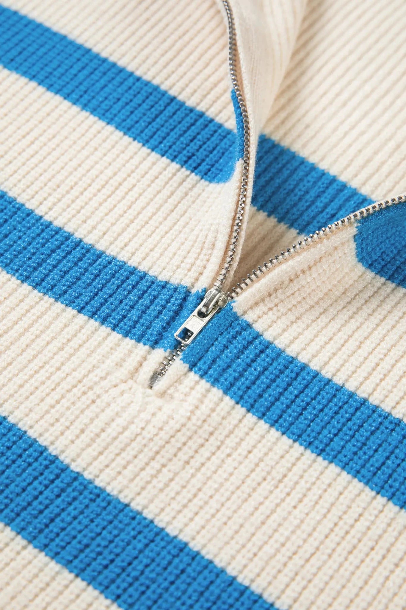Close-up of a blue and white striped fabric with a zipper.