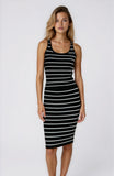 Woman wearing a black and white striped dress on a white background