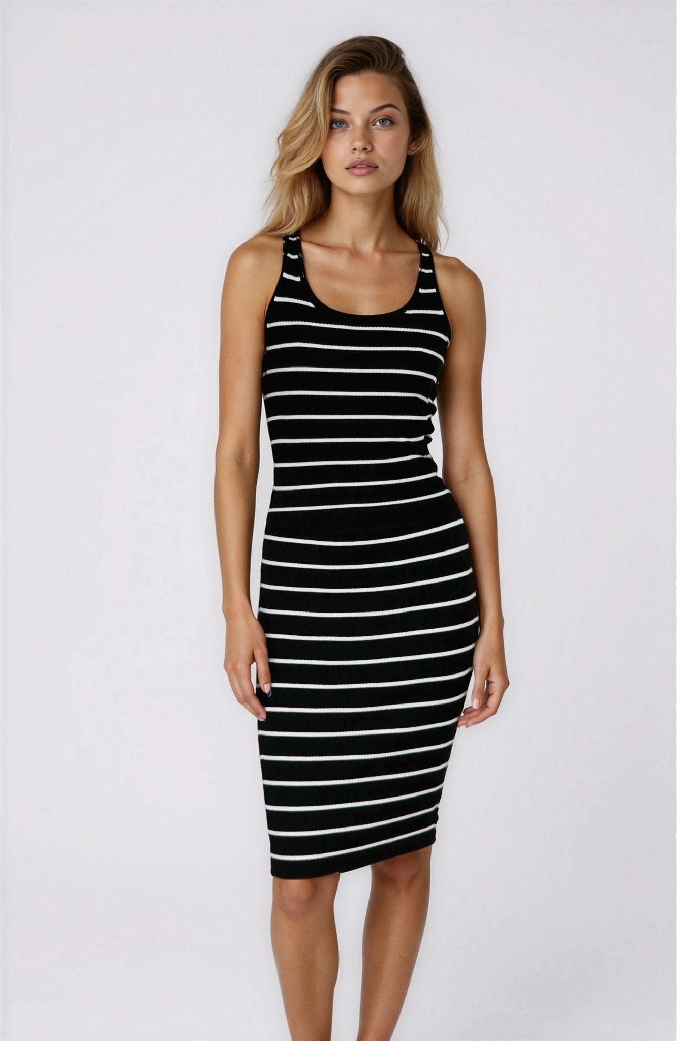 Woman wearing a black and white striped dress on a white background