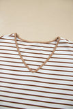 Close-up of a white V-neck top with brown stripes and contrasting brown neckline trim.