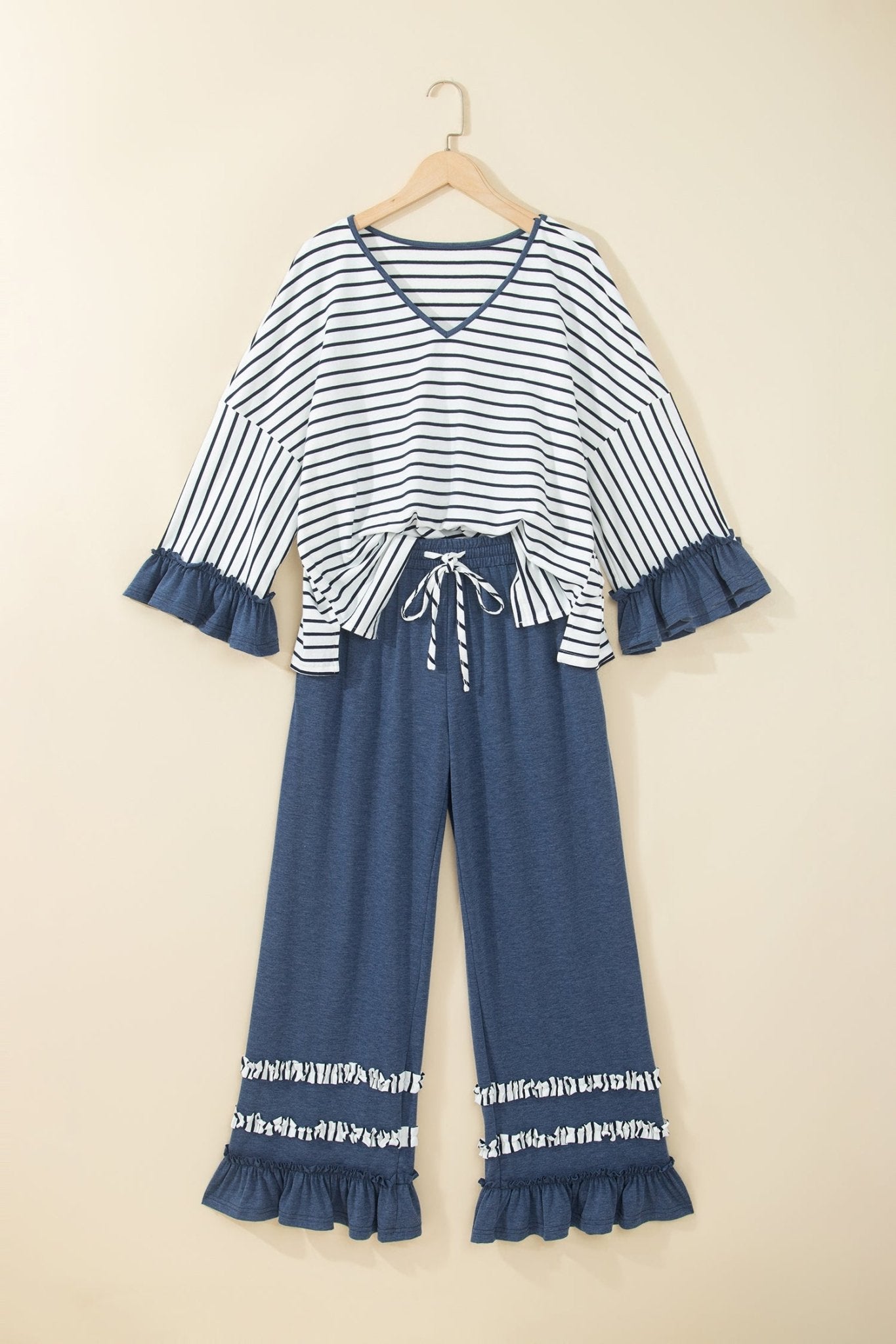 Children's two-piece set with navy striped top, blue ruffles, drawstring waist, and wide-leg pants.