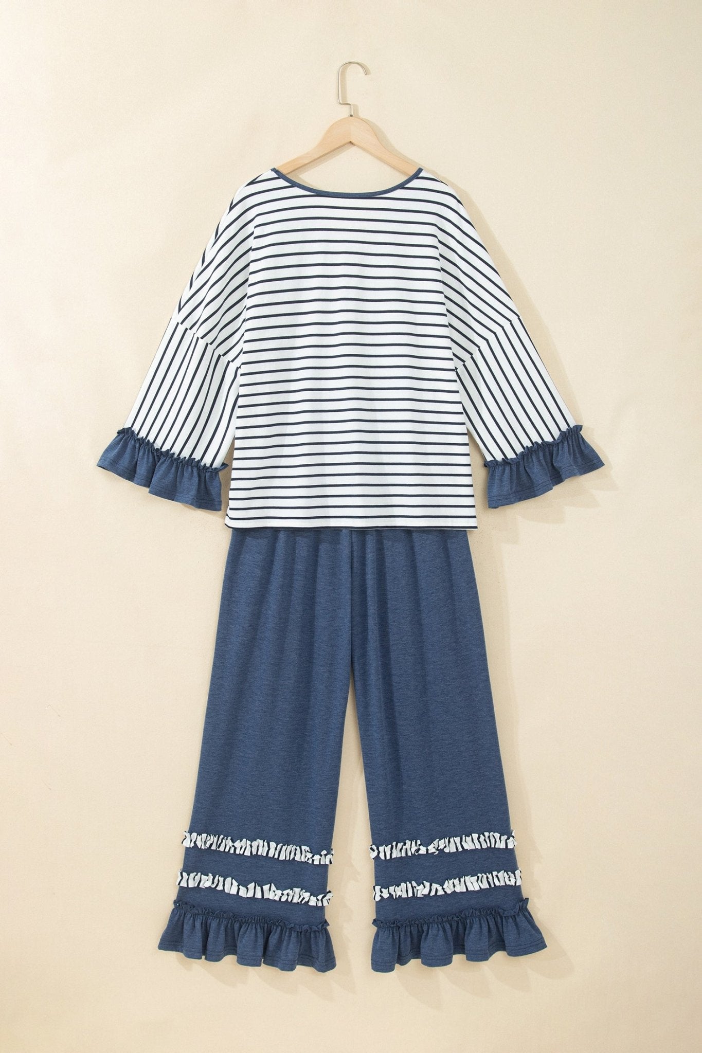 Children's two-piece pajama set with navy striped top and matching wide-leg pants with ruffled hems.
