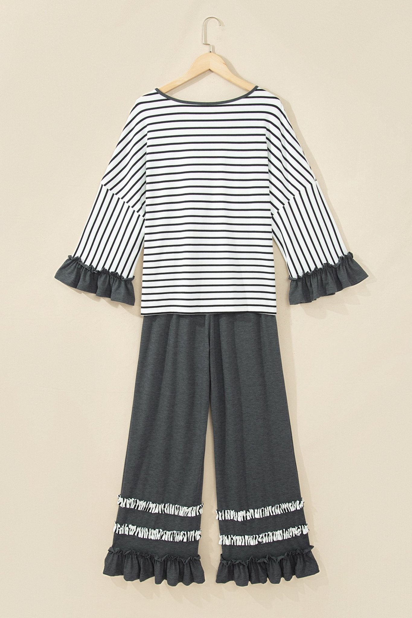 Girls' two-piece set with striped long-sleeve top and gray wide-leg pants with ruffled hems.
