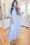 Woman taking a mirror selfie wearing a blue and white striped dress in a living room.