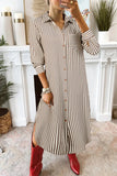 Person wearing a long striped shirt dress with red shoes in a home setting.