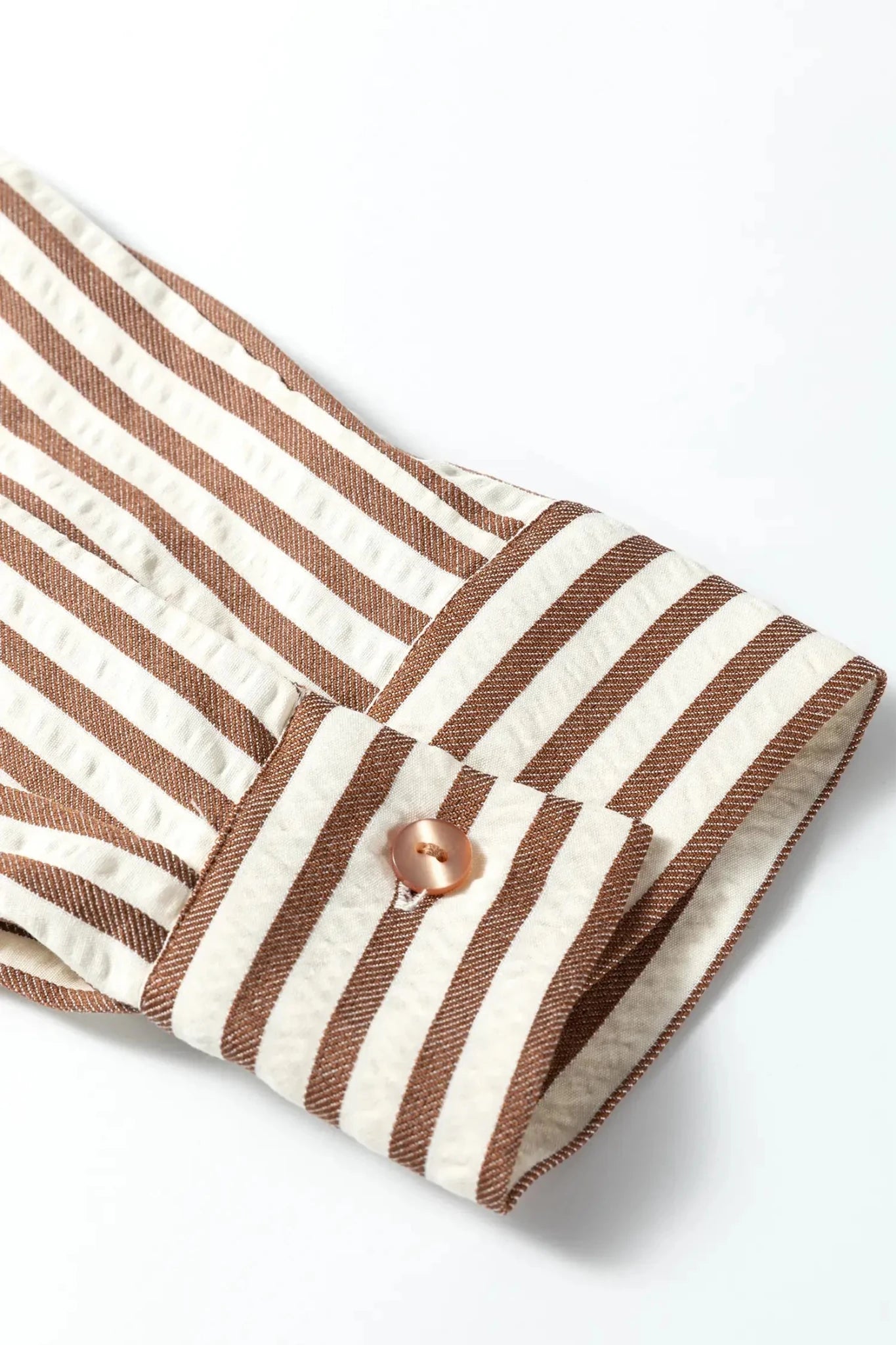 Striped fabric with a button on a white background