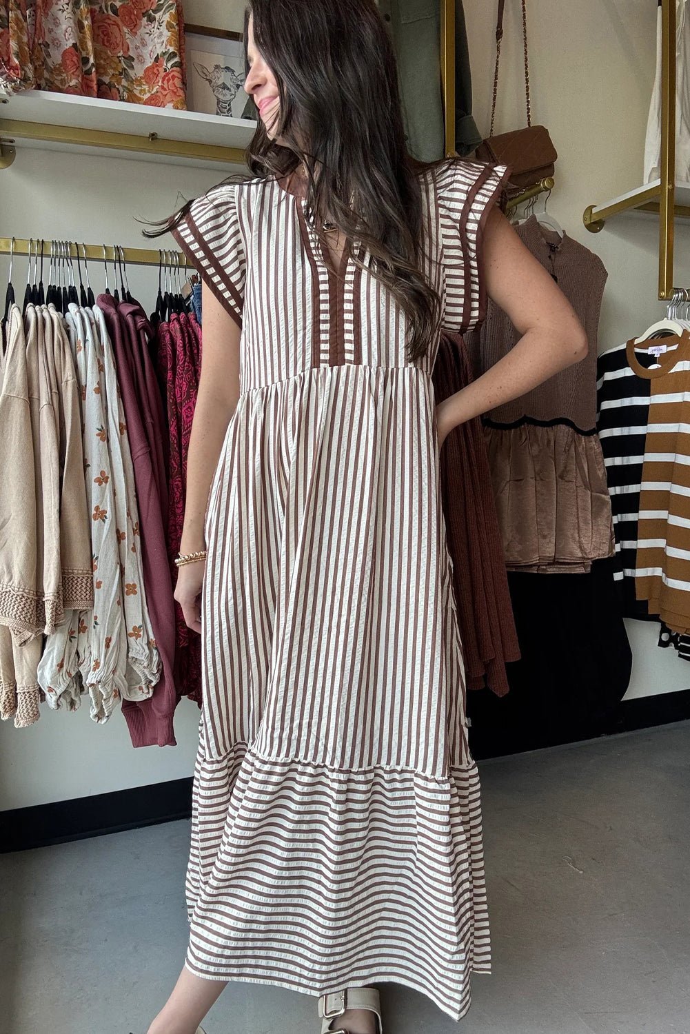 Woman wearing a striped dress in a clothing store