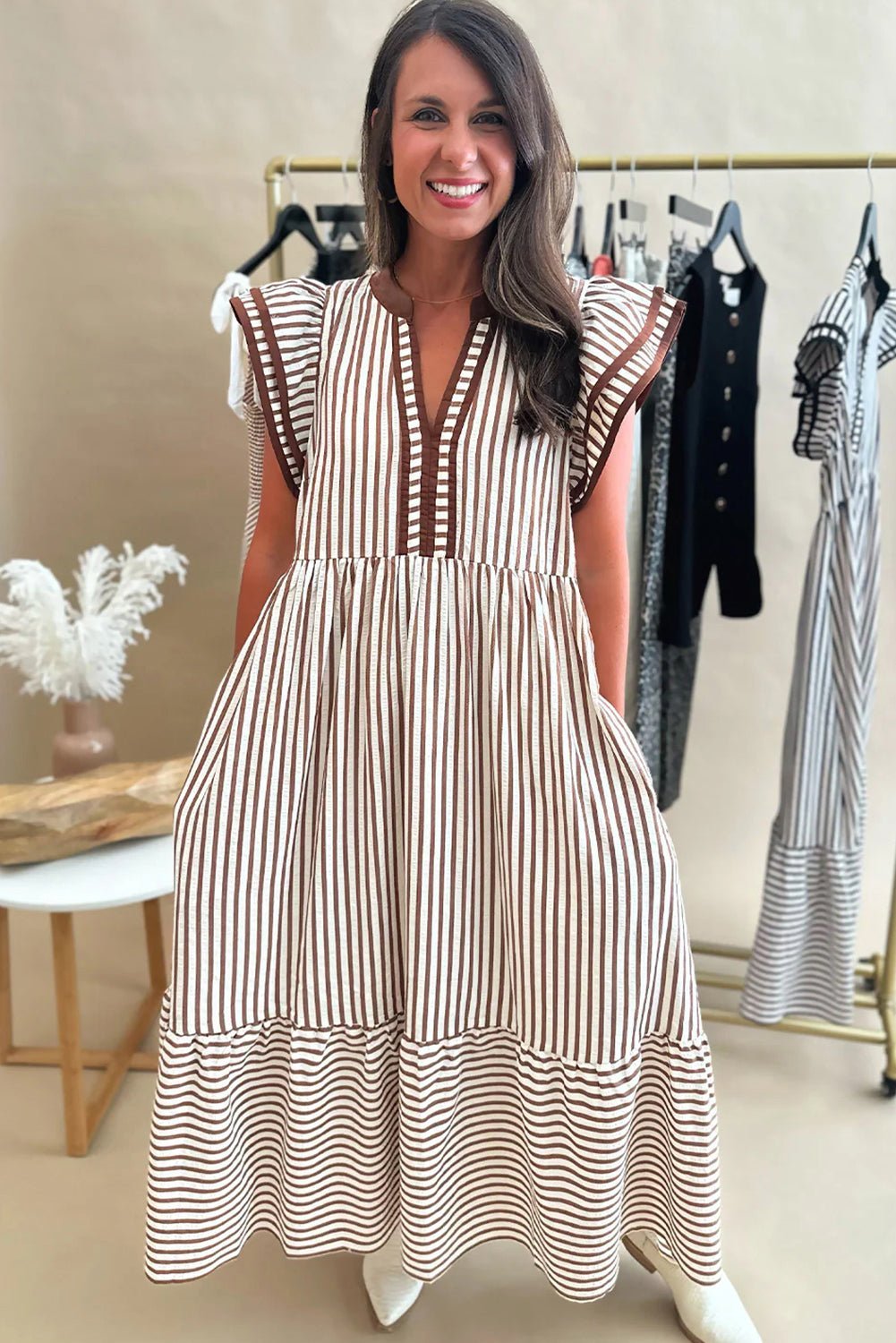 Woman wearing a striped dress in a clothing store