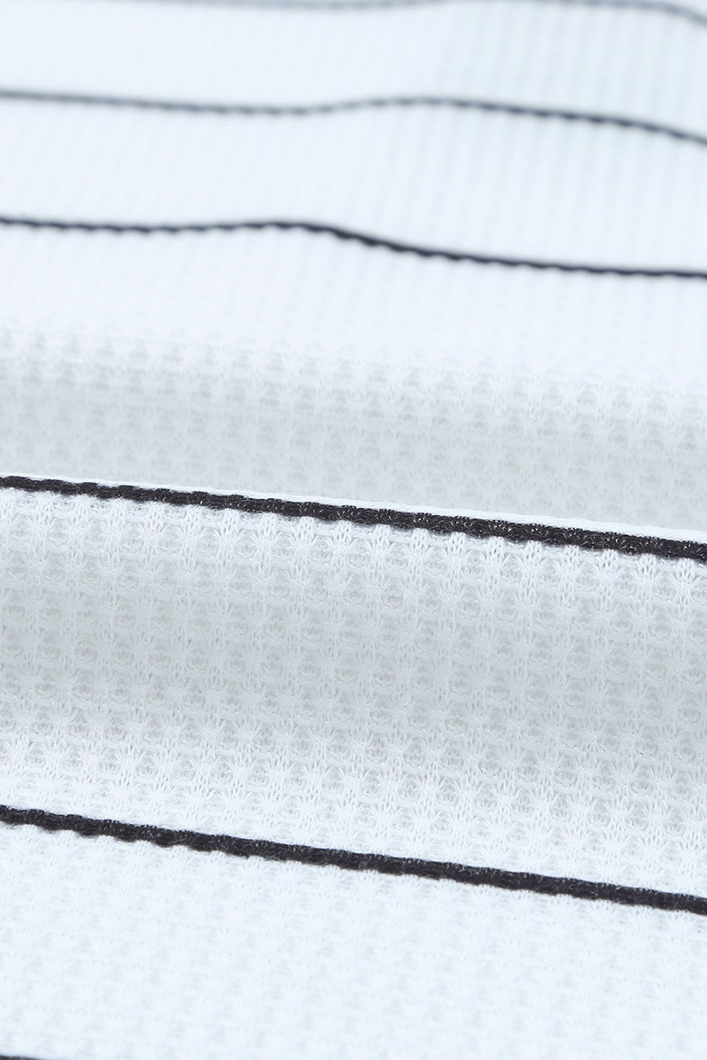 Close-up of white fabric with black stripes