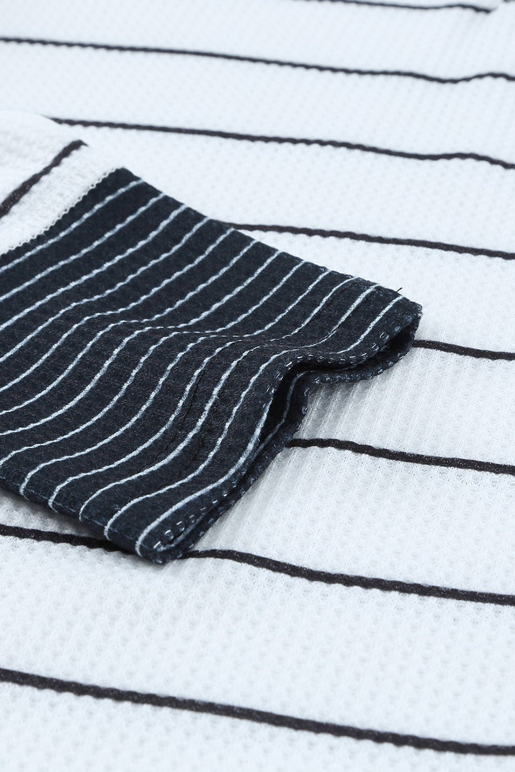 Black and white striped fabric on a white background with black lines