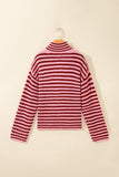 Pink-dark red striped knit mock-neck sweater hanging on a wooden hanger.