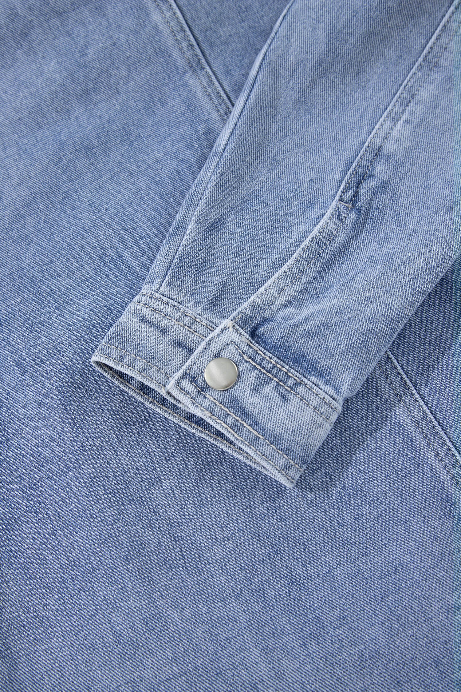 Light blue denim jacket buttoned cuff detail