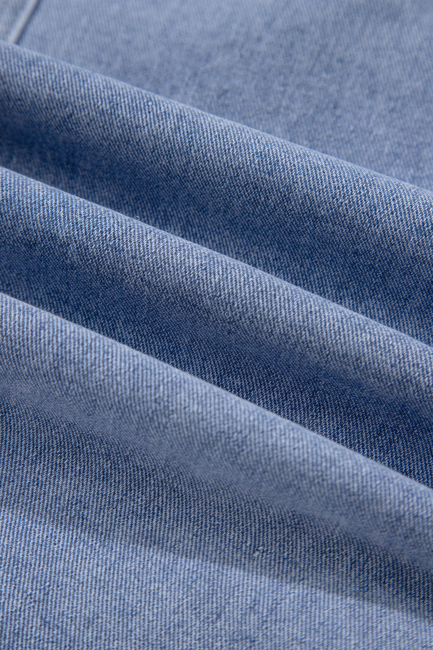 Close-up of light blue washed denim fabric