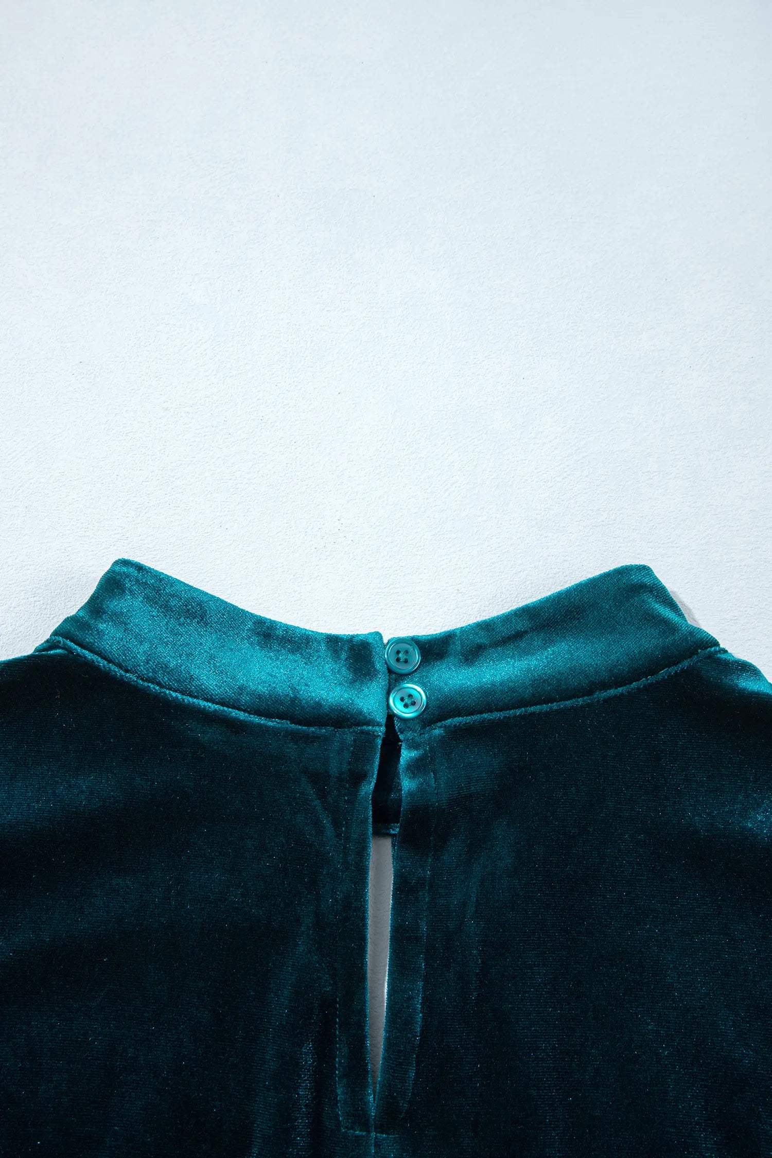 Back mock neck with button closure on teal velvet dress