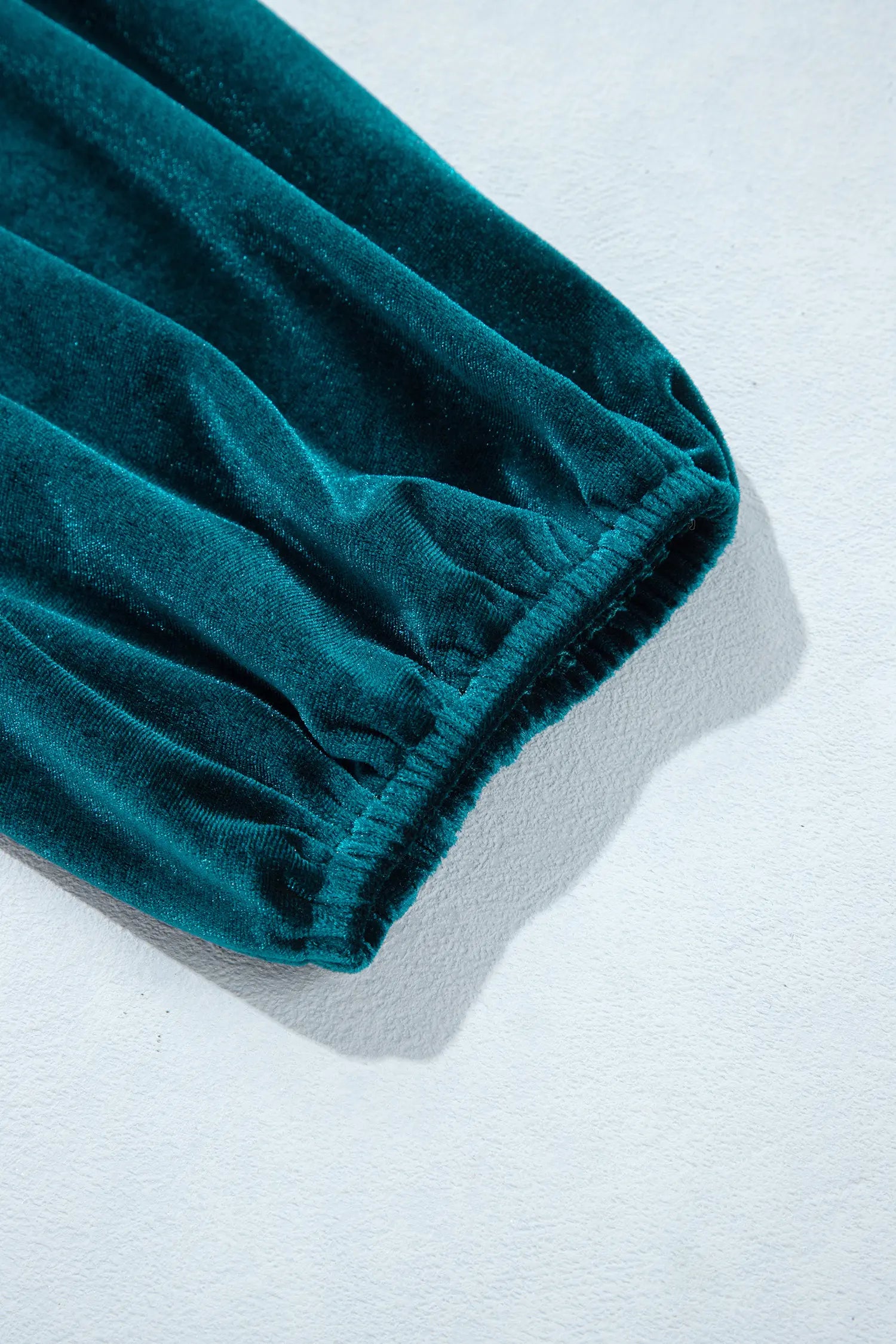 Elastic balloon sleeve cuff on teal velvet mini dress