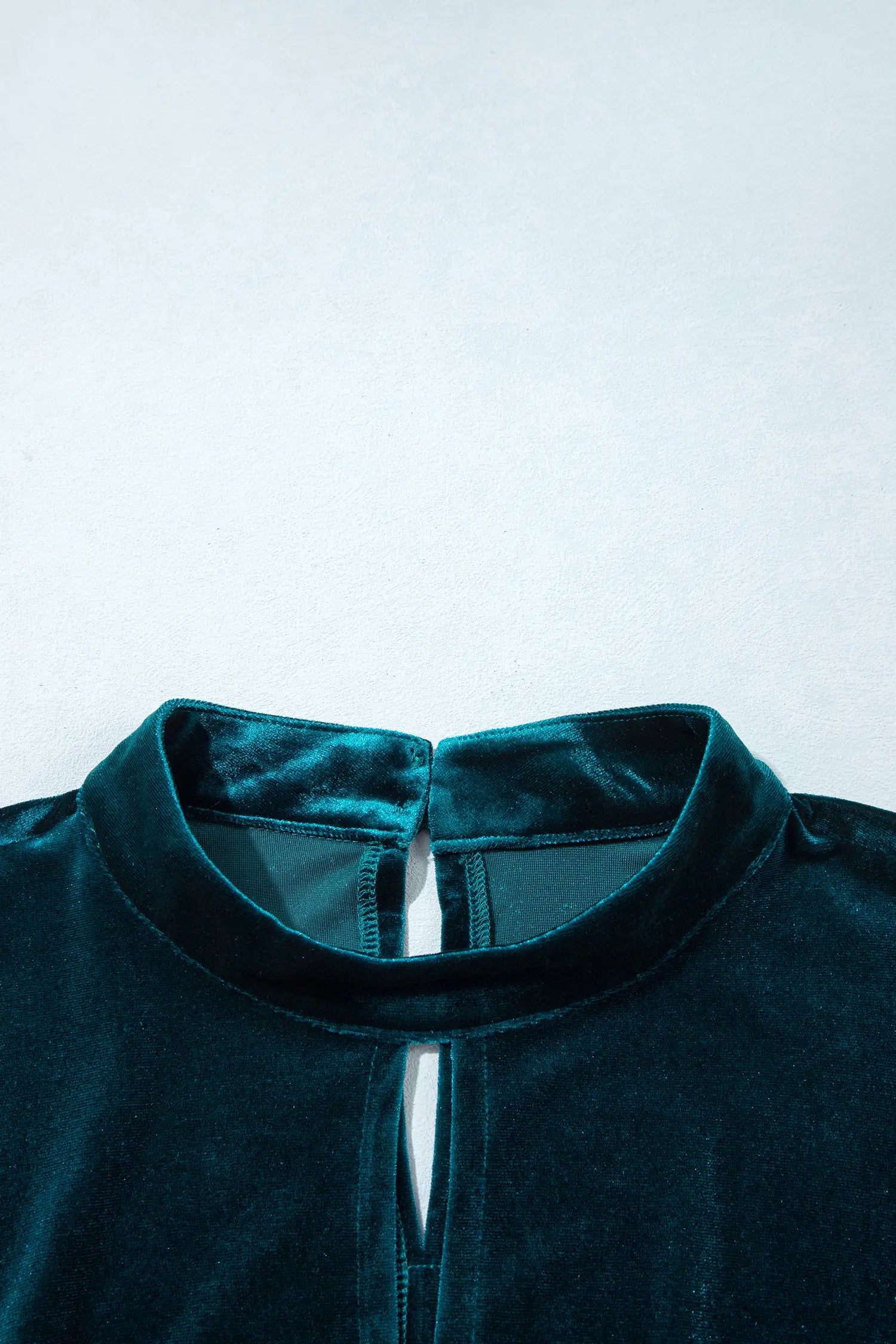 Front keyhole mock neckline on teal velvet mini dress