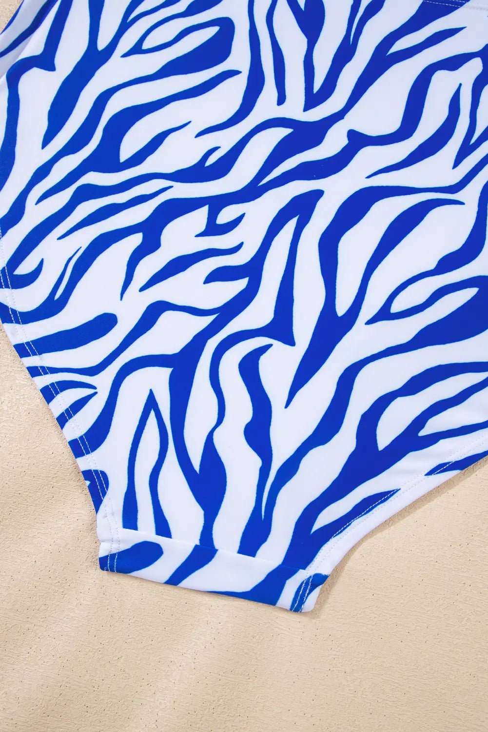 Blue and white zebra patterned fabric on a beige background