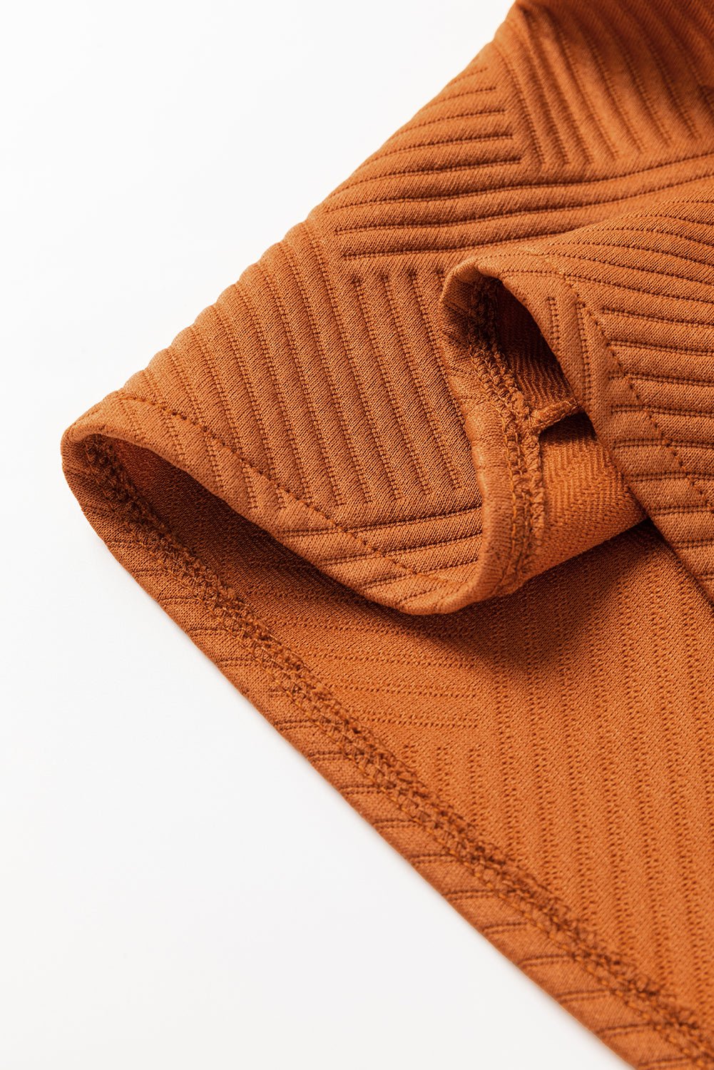 Close-up of a brown textured fabric on a white background