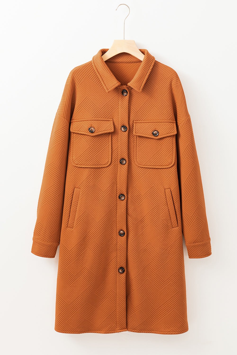 Brown coat on a hanger against a white background