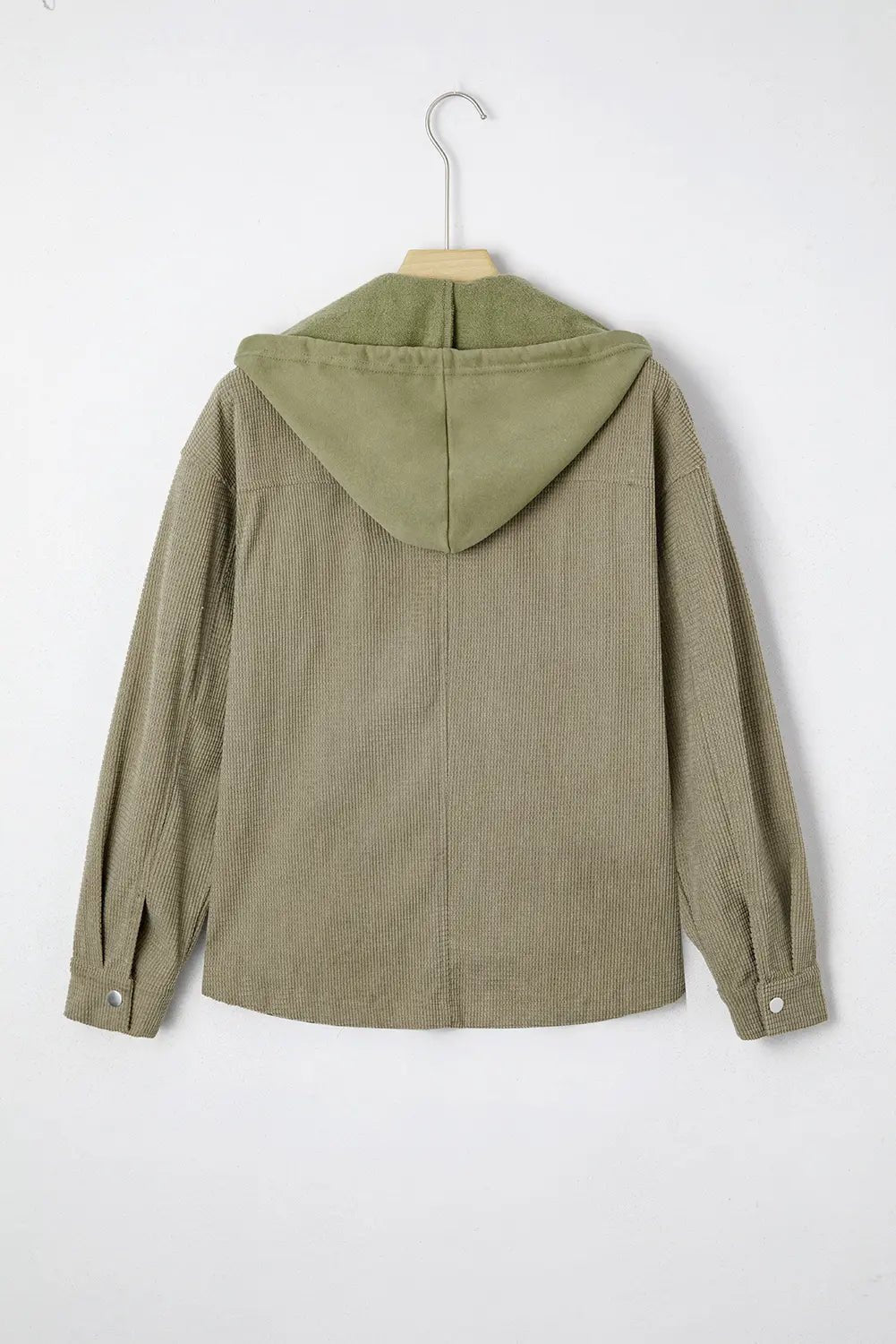 Green jacket with a hood on a hanger against a white background