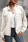 Person wearing a white denim jacket over a white top and blue jeans.