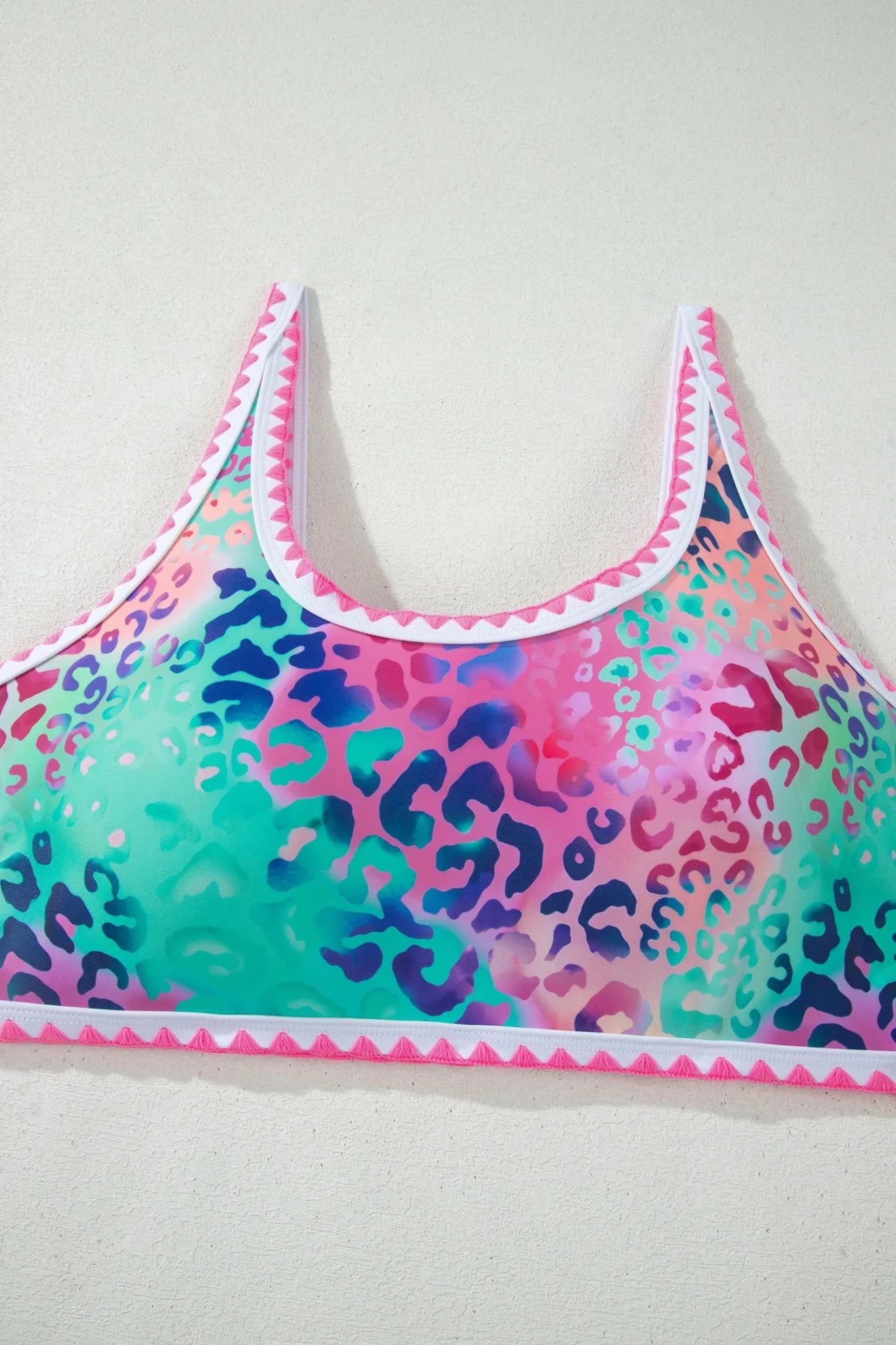 Colorful leopard print sports bra on a light gray background