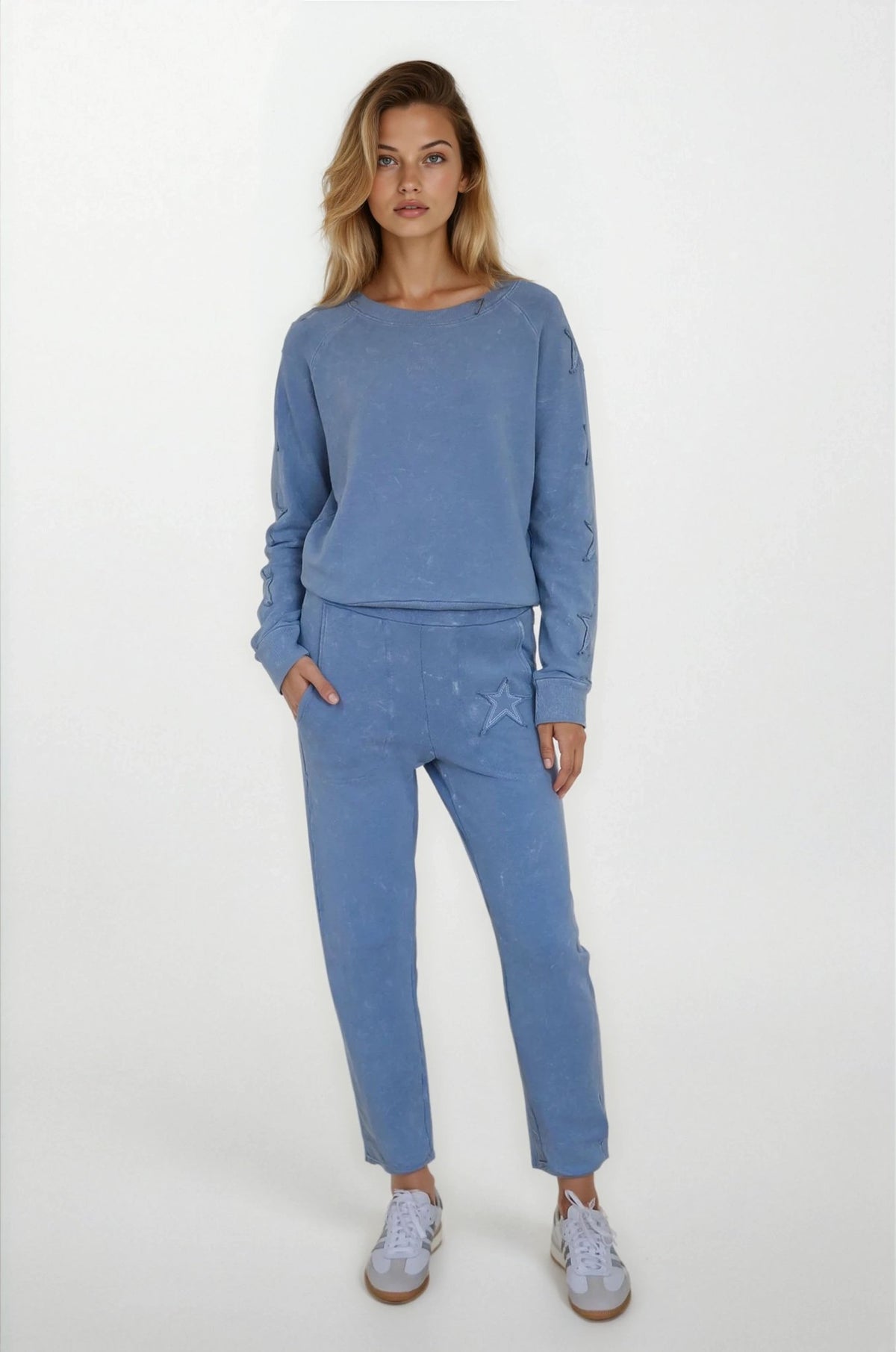 Woman wearing a blue outfit with a plain background