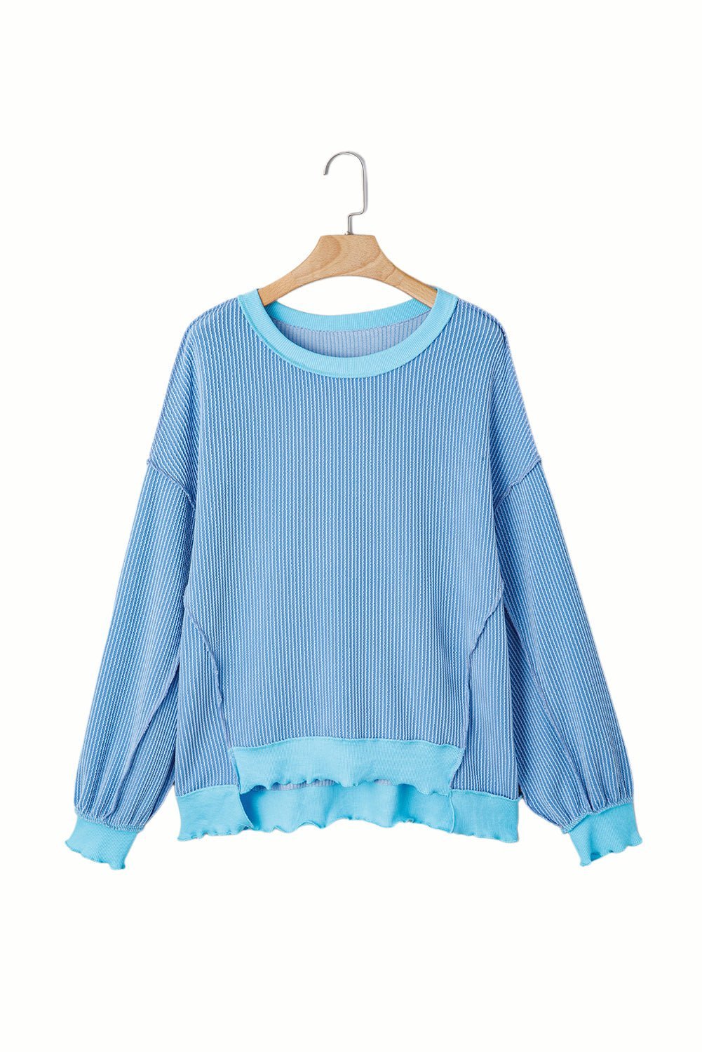 Blue sweater on a hanger against a white background