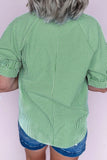Person wearing a green and white striped shirt with blue shorts on a white background