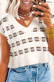 Woman wearing a white and brown plaid top with denim shorts, holding a phone.
