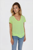 Woman wearing a light green blouse with lace trim on a white background