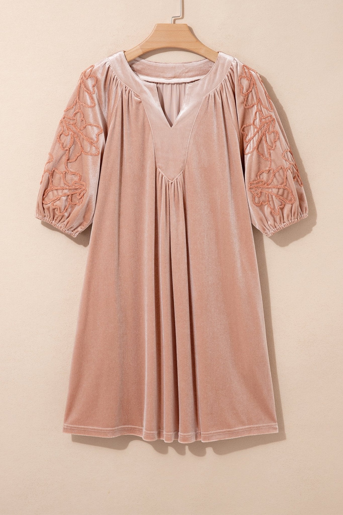 Dusty pink velvet nightgown dress with embroidered puff sleeves on hanger against beige.